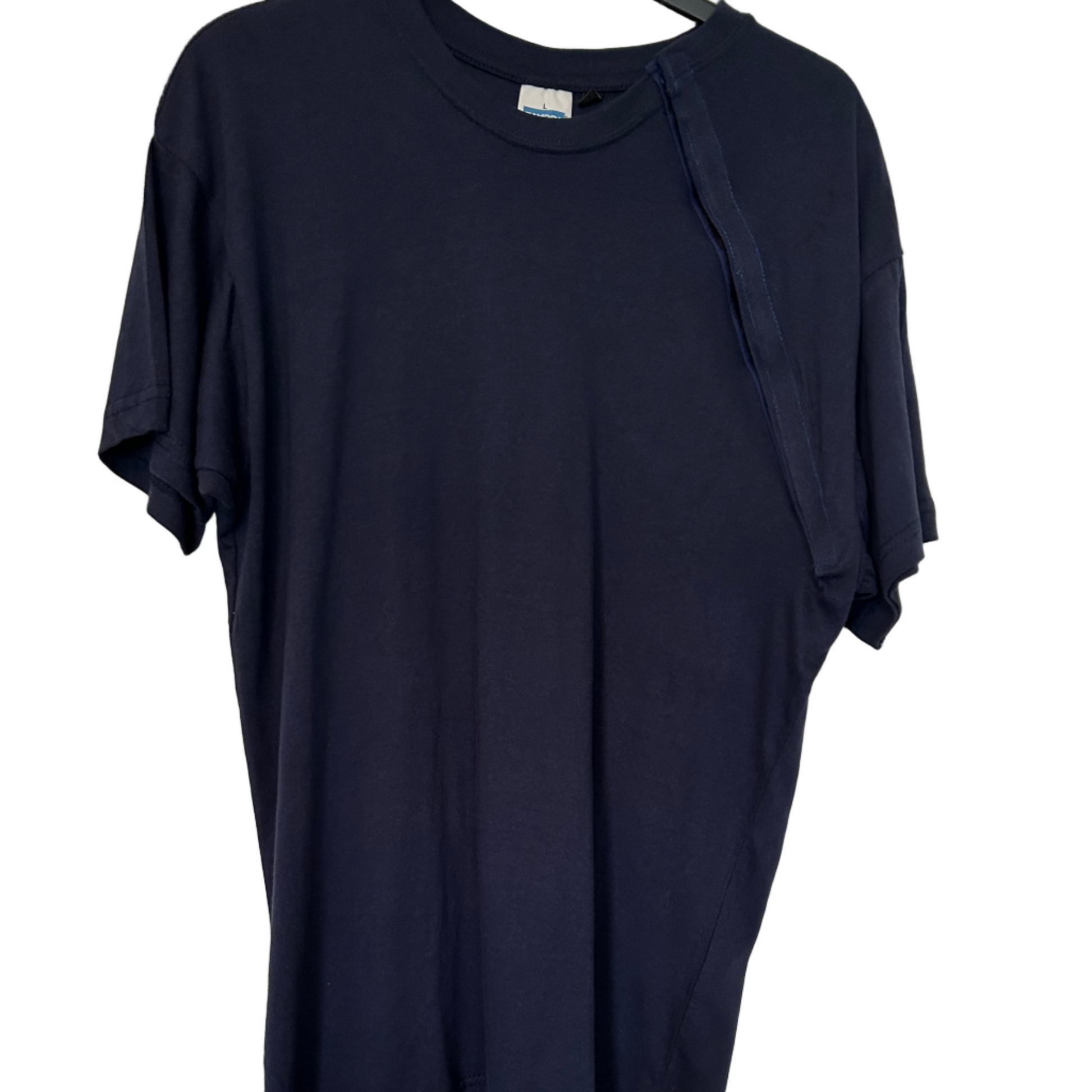 Black t-shirt on a hanger against a white wall