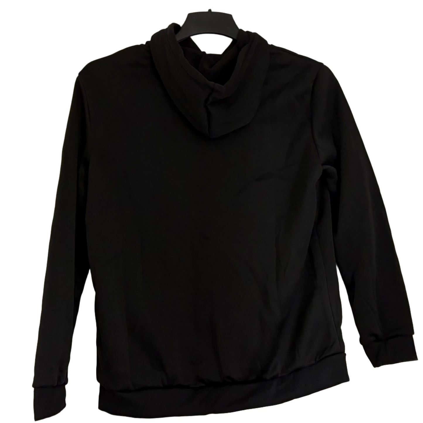 Black sweatshirt hanging on a door in a room with white walls and gray curtains.