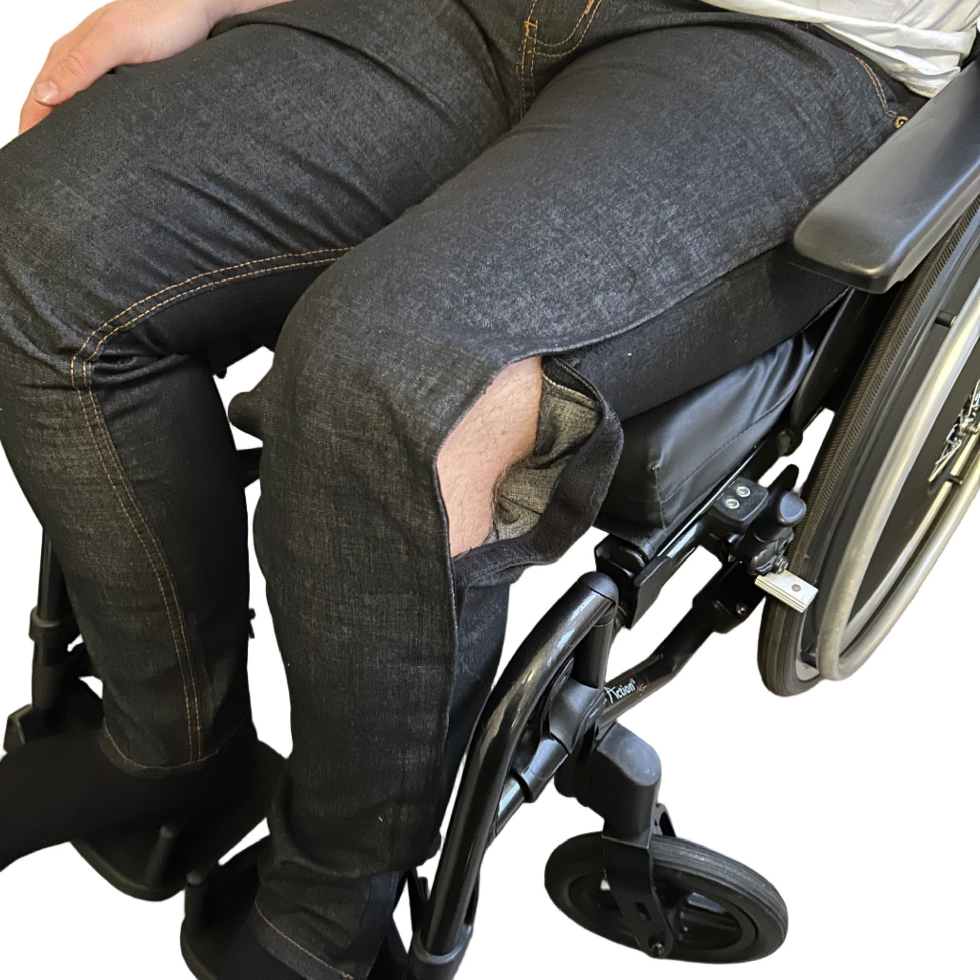 Person in a wheelchair wearing dark jeans and a white shirt.