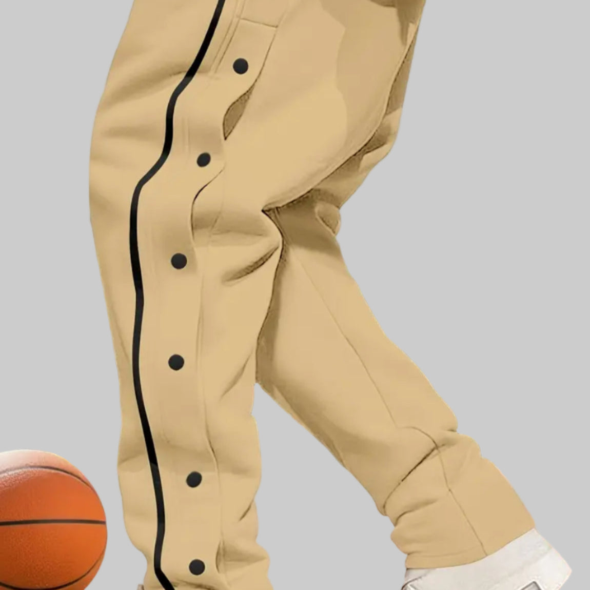 Beige pants with black buttons on a basketball court